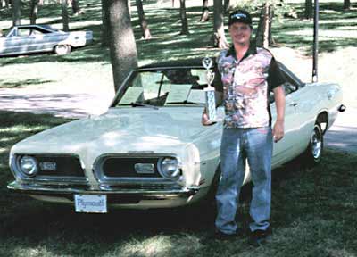 John's proud of that car and trophy!